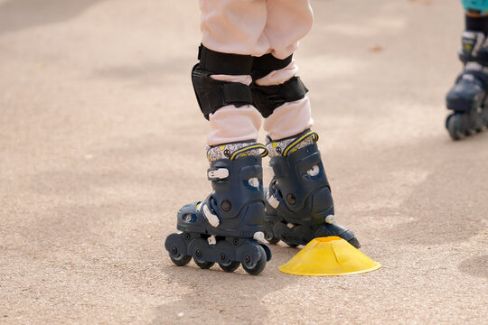 Child learning inline skating wearing protective gear