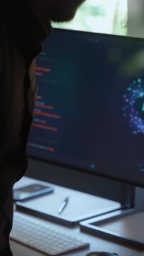 Programmer types a prompt for AI assistant on his computer and lets the Artificial Intelligence agent work on coding project independently instead of him. Automation and task delegation using AI. 