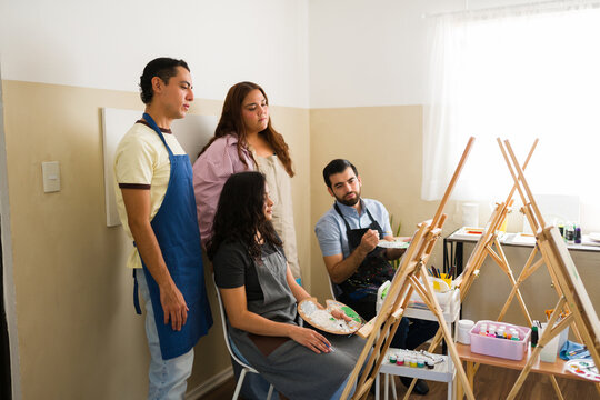 Art class group learning painting techniques in a studio, engaging in a creative and educational hobby