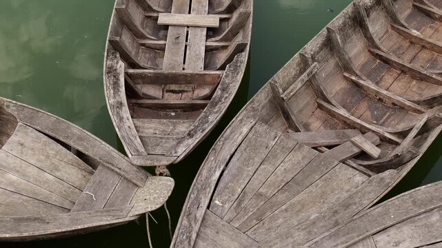 Top view of traditional wooden sampan boats floating on water