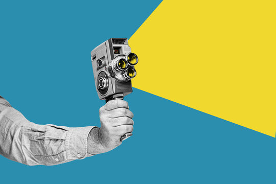 A hand holding retro film camera. Vintage cinema poster.