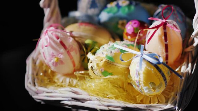 Close up of ornate easter eggs in decorative basket with soft lighting.