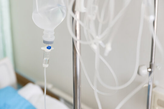 Close up set iv fluid intravenous drop saline drip for accident and seriously patient in hospital room.Medical treatment emergency patient.Medical treatment and cure concept.