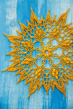 Beautiful golden crochet doily with intricate lace patterns and detailed texture, showcasing traditional handmade craftsmanship, elegant design, and vintage tabletop decor in Kladno, Czech Republic