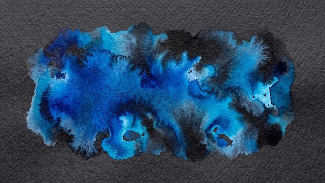 Blue watercolor paint bleeding dynamically on textured dark paper