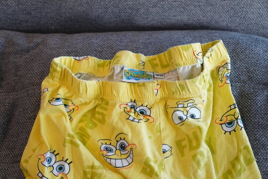 Bright yellow SpongeBob SquarePants pajama bottoms with a fun cartoon character print pattern