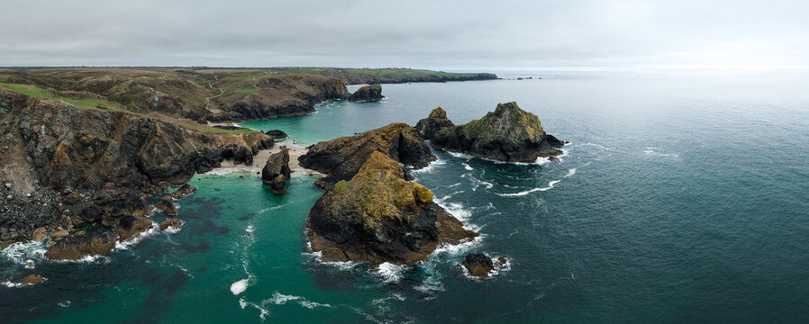 Aerial panorama landscape of Kynance Cove in Cornwall, UK with beach and calm ocean