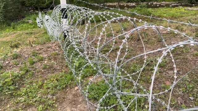   
Inside view of Egoza, razor wire, Bruno spiral of steel, sharp barbed coils forming hostile barrier, symbol of war, border, confinement, resistance