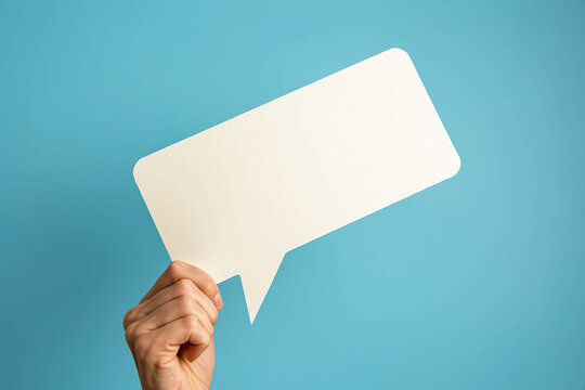 Hand holding blank white speech bubble sign photo illustration   