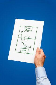 Hand holding soccer tactics strategy sheet photo illustration