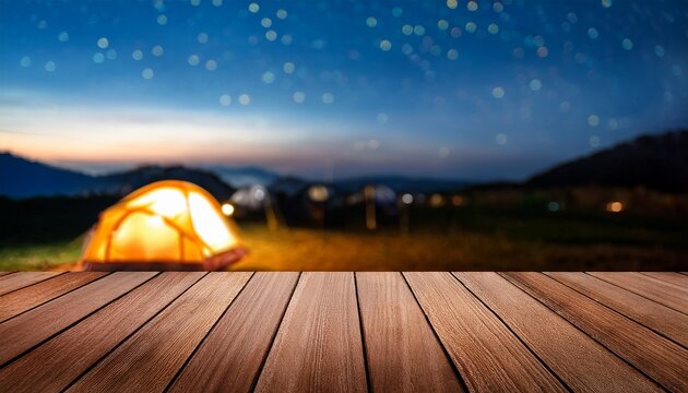 wooden table on blur tent camping at night background