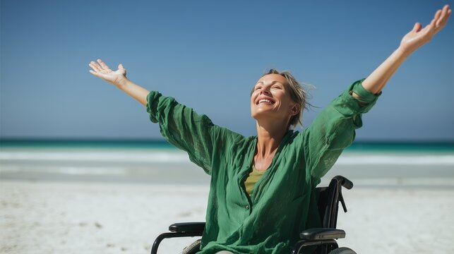 A cheerful close-up portrait of a mature woman in a green linen shirt sitting in a wheelchair, looking up and laughing with open arms under bright sunlight against the sky. 