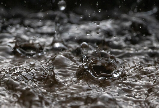 Closeup of Heavy Rain Striking Water