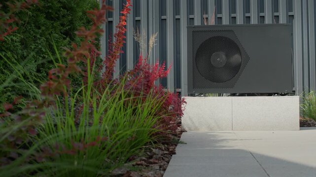 Air source heat pump outdoor unit operating efficiently in residential garden, modern energy saving system working.