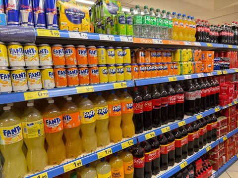 Mallorca, spain, septiembre 18, 2026 supermarket aisle displaying rows of fanta and coca cola soft drinks, offering variety and choice in a retail setting