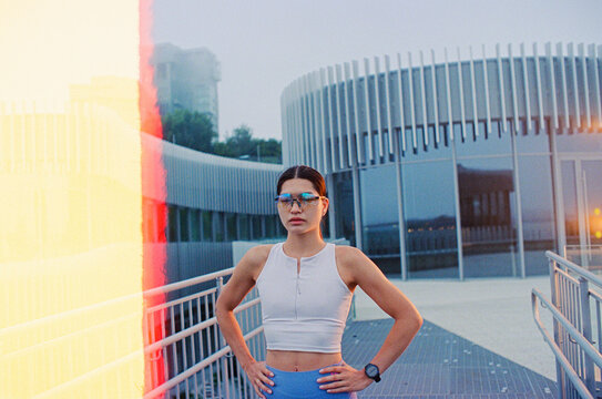 Young female jogger rests between cardio exercises