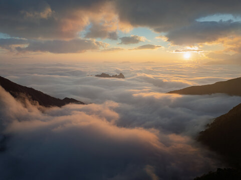 Sunrise above clouds in a dramatic mountain landscape