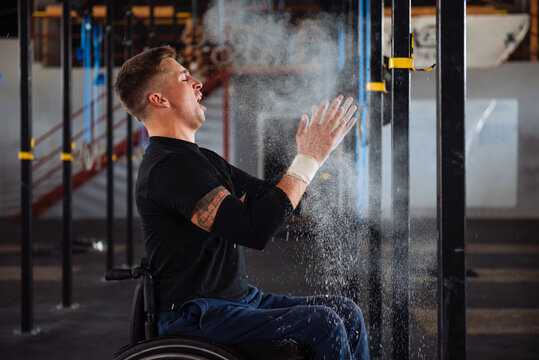 Wheelchair Athlete Preparing With Chalk In Gym