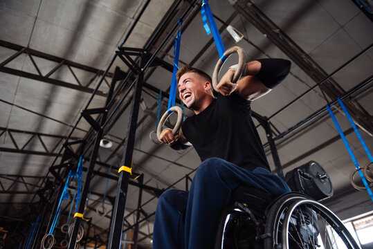 Wheelchair Athlete Training on Gym Rings With Determination