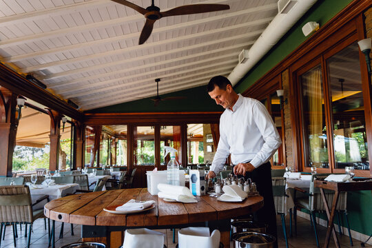 Waiter Preparing a Restaurant Table for Service