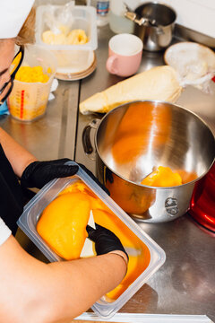 Chef Preparing Mango Mixture in a Kitchen