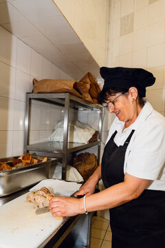 Baker slicing bread