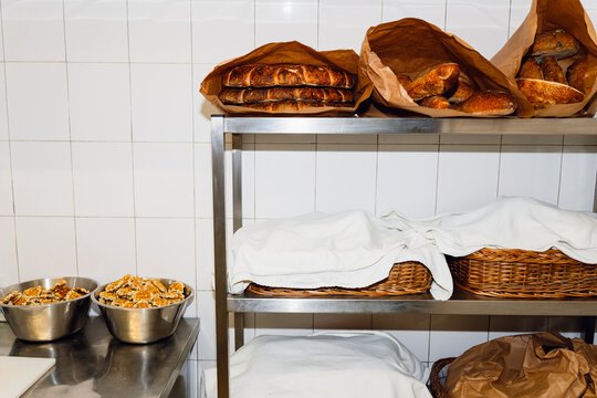 Fresh Bread Stored on Shelves in a Restaurant Kitchen