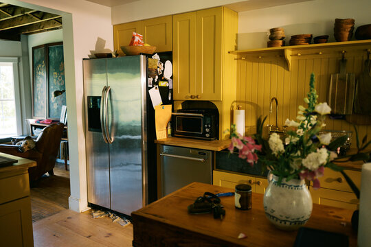 real imperfect kitchen with yellow cabinetry