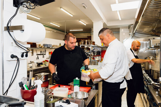 Chefs Working Together in Restaurant Kitchen