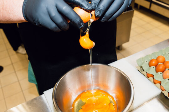 Cracking eggs in kitchen