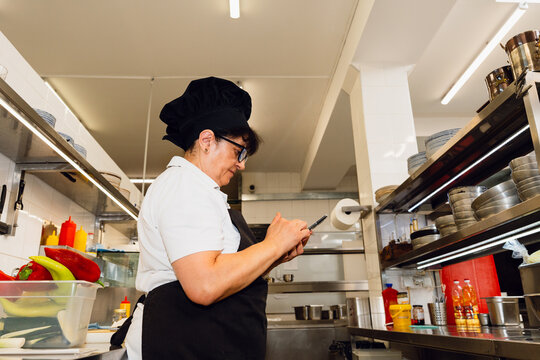 Kitchen Worker Using Smartphone