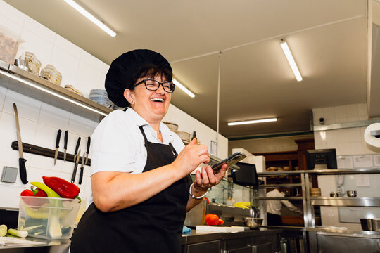 Kitchen Worker Using Smartphone