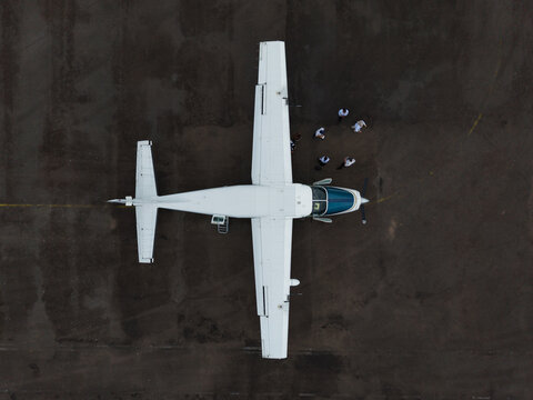 Overhead View of Turboprop Plane with Ground Crew