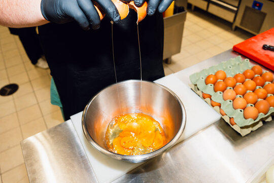 Cracking eggs in kitchen