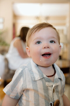 Candid toddler smile at home with curious, joyful expression