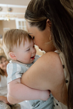 Mother holding baby close in a candid tender moment