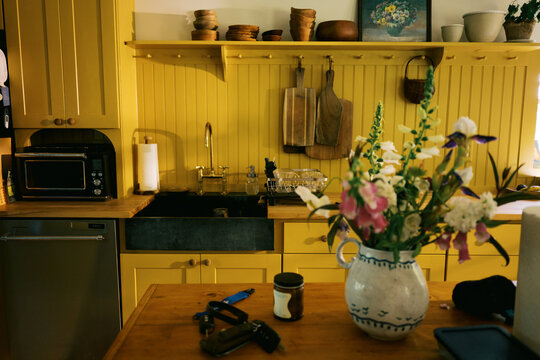 real imperfect kitchen with yellow cabinetry