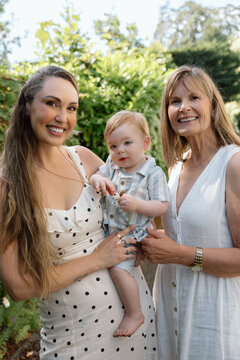 Candid three generation family portrait with smiling baby