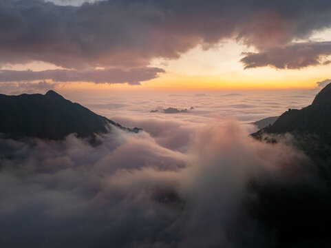 Mountain Peaks Above a Sea of Clouds at Sunset