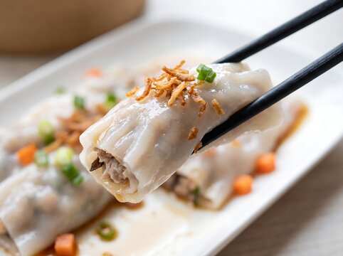 Delicious steamed dumplings with chopsticks on a white plate