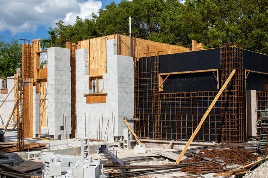 Steel rebar reinforcement cage and wooden formwork framing a concrete wall installation at a modern construction site