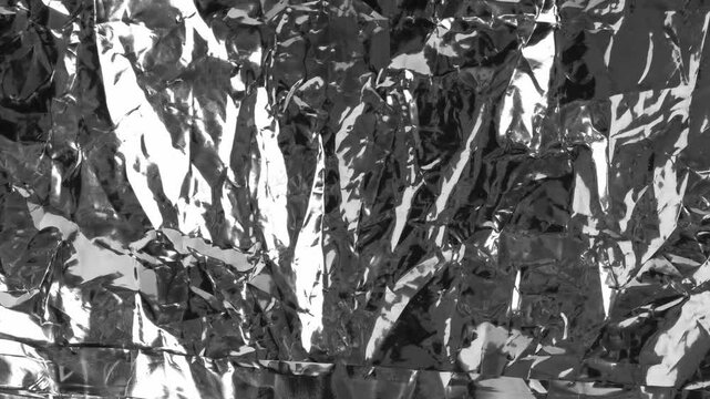 Silver foil textured background, crumpled aluminum pattern loop. Sparkle metal paper wallpaper, glossy solver foil packaging bg, reflective gray food wrapping