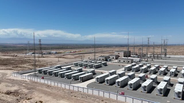 rows of battery energy storage containers in desert landscape