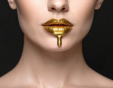 Extreme Close-Up of Lips with Dripping Golden Liquid Makeup