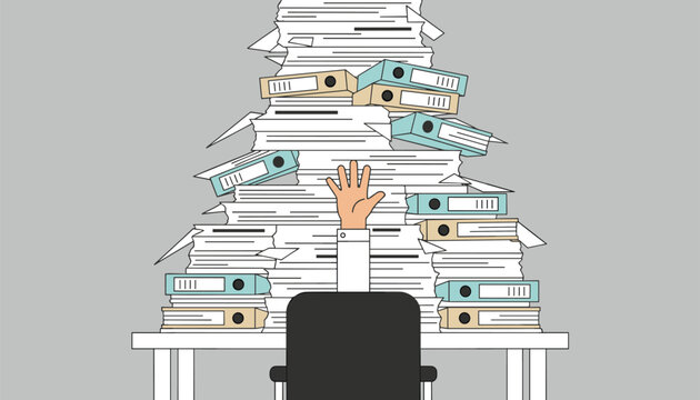 Office desk overloaded with a massive stack of paperwork files and binders while person raises one hand.