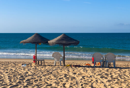 Lifeguard rescue can on the beach. Orange rescue buoy in vertical position on the sand. 