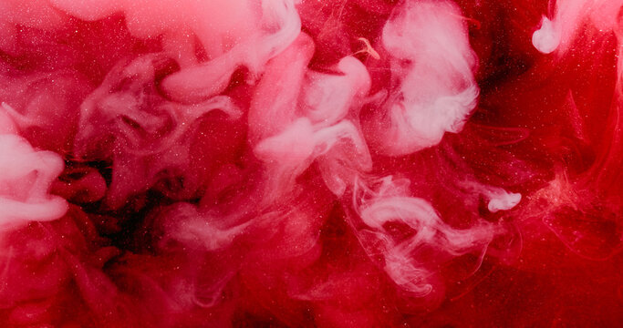 Haze splash. Underwater ink drop. Defocused red pink color glitter spreading cloud water vibrant acrylic art fluid on abstract background.
