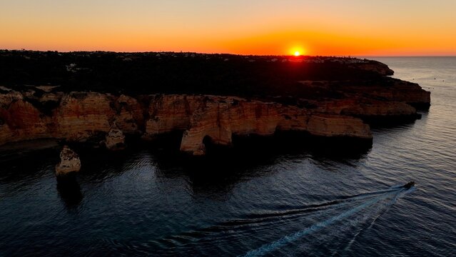 Breathtaking panoramic sunset beach shore, radiant golden sky over turquoise ocean waves, serene summer vacation paradise travel background
