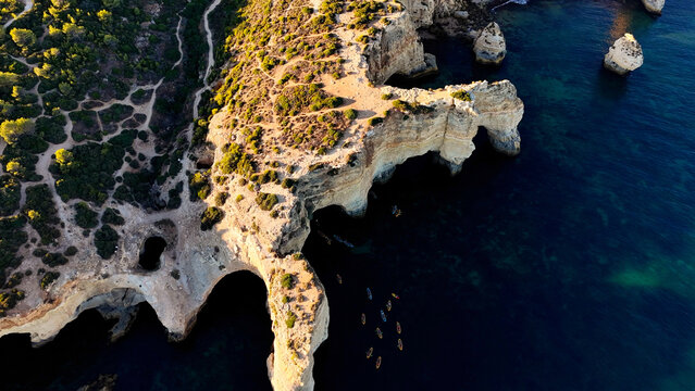 Aerial view of rocky coastal formations above turquoise sea in Portugal. Algarve. Beach 