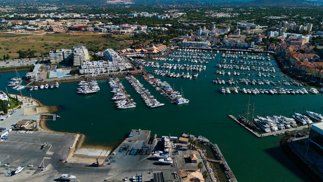 Beautiful aerial perspective of Vilamoura marina. Luxury hotels, yachts docked in the port. Famous travel destination in south of Portugal. Algarve region 
